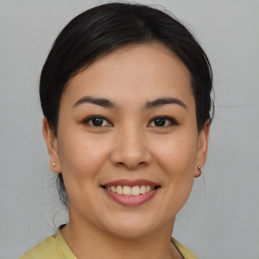 Joyful asian young-adult female with short  brown hair and brown eyes