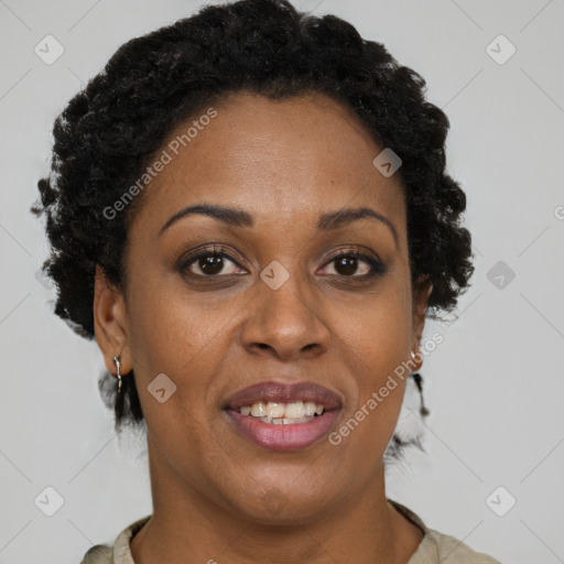Joyful black adult female with short  brown hair and brown eyes