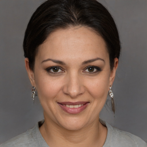 Joyful white adult female with short  brown hair and brown eyes