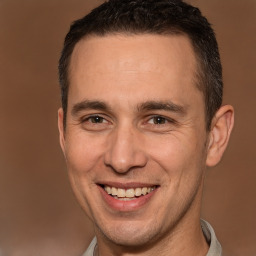 Joyful white adult male with short  brown hair and brown eyes