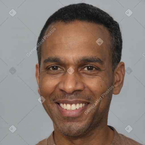 Joyful latino adult male with short  black hair and brown eyes