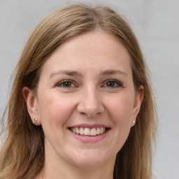 Joyful white young-adult female with long  brown hair and grey eyes