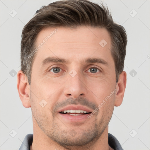 Joyful white adult male with short  brown hair and brown eyes