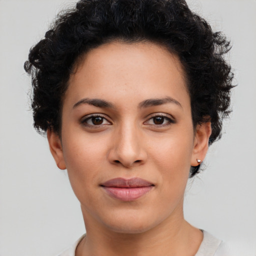 Joyful latino young-adult female with short  brown hair and brown eyes