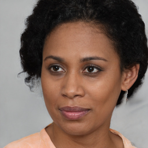 Joyful latino adult female with short  brown hair and brown eyes