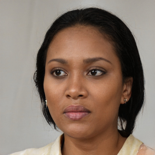 Neutral black young-adult female with medium  black hair and brown eyes