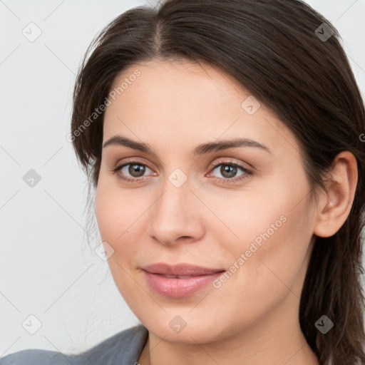 Joyful white young-adult female with long  brown hair and grey eyes