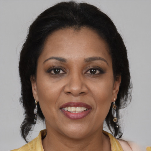 Joyful latino adult female with medium  brown hair and brown eyes