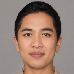 Joyful asian young-adult male with short  black hair and brown eyes