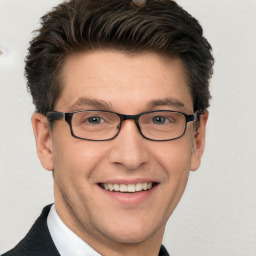 Joyful white adult male with short  brown hair and brown eyes