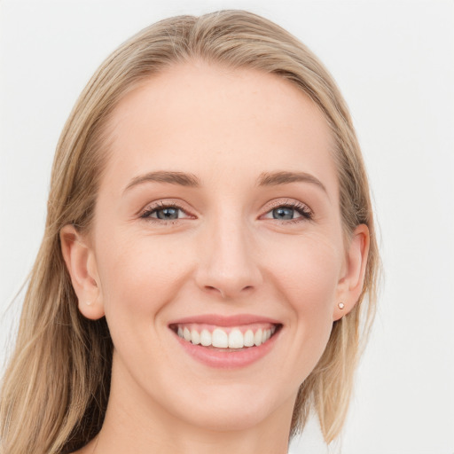 Joyful white young-adult female with long  brown hair and blue eyes