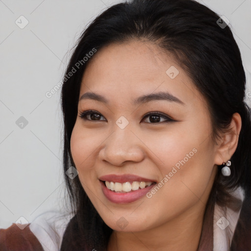 Joyful asian young-adult female with long  brown hair and brown eyes