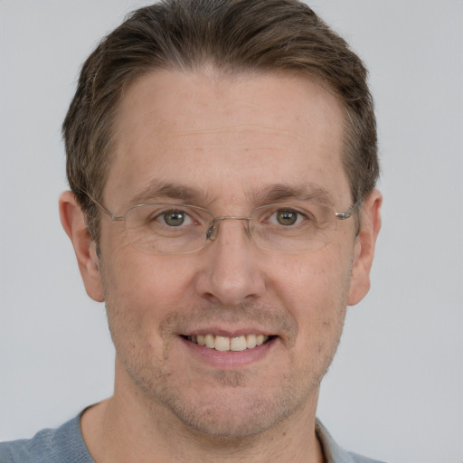 Joyful white adult male with short  brown hair and grey eyes