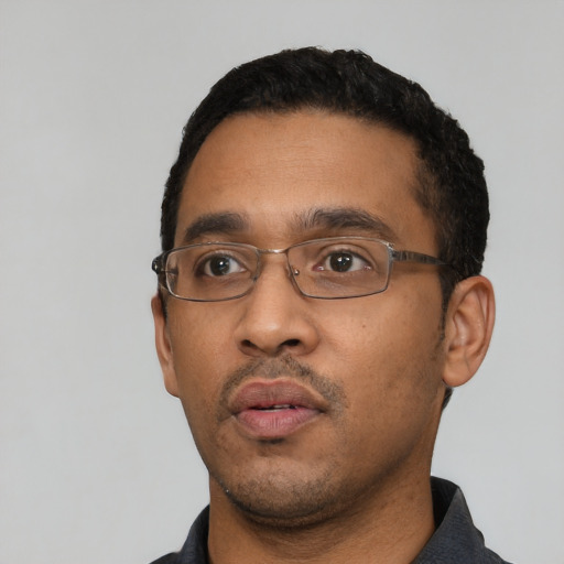 Neutral black adult male with short  black hair and brown eyes
