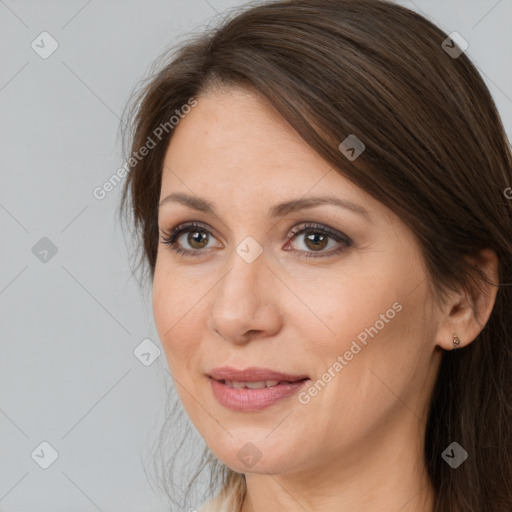 Joyful white adult female with long  brown hair and brown eyes