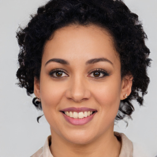Joyful latino young-adult female with medium  black hair and brown eyes