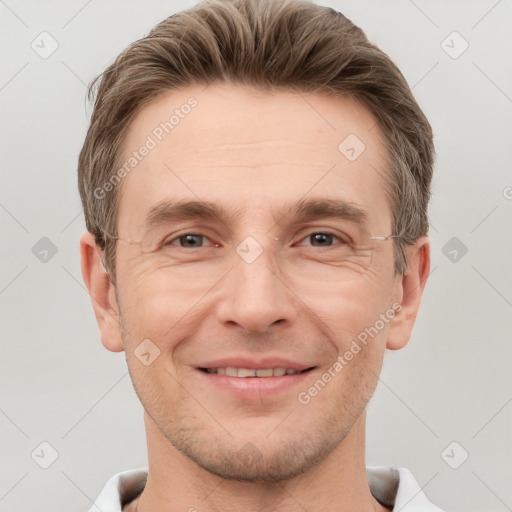 Joyful white adult male with short  brown hair and grey eyes