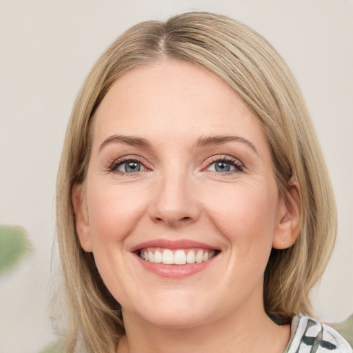 Joyful white young-adult female with medium  brown hair and green eyes