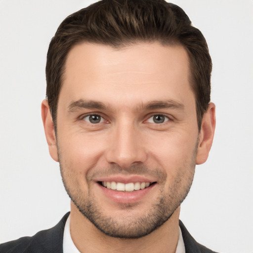 Joyful white young-adult male with short  brown hair and brown eyes