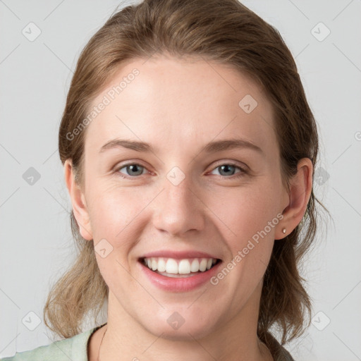 Joyful white young-adult female with medium  brown hair and grey eyes