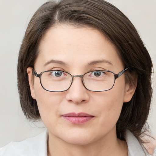 Joyful white adult female with medium  brown hair and grey eyes