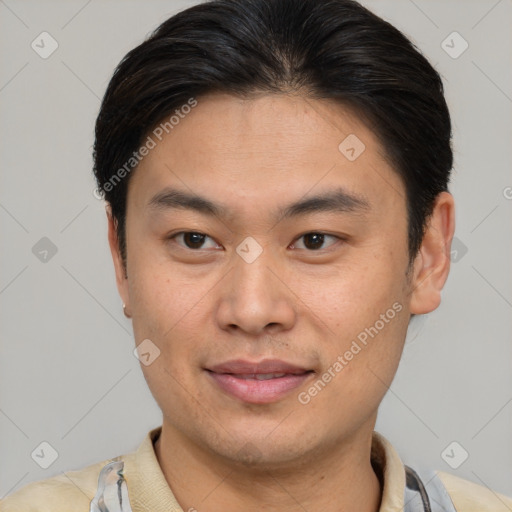 Joyful asian young-adult male with short  brown hair and brown eyes