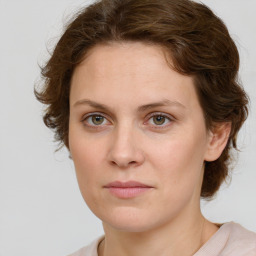 Joyful white young-adult female with medium  brown hair and green eyes