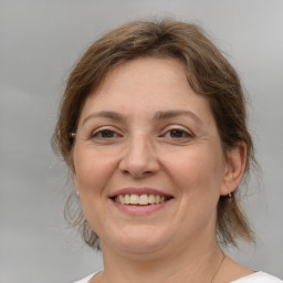 Joyful white adult female with medium  brown hair and brown eyes