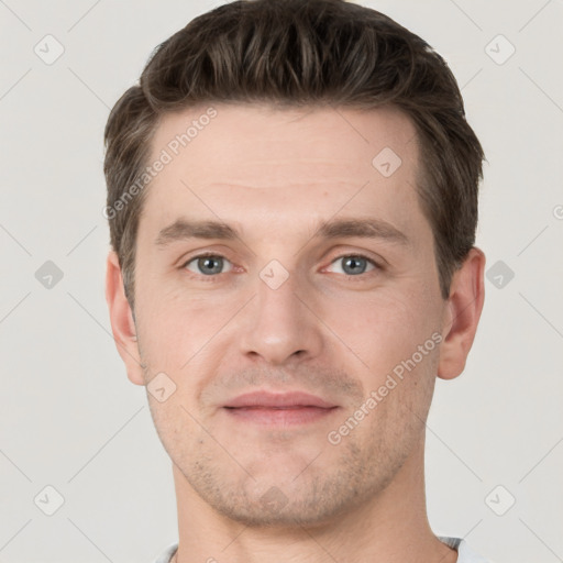 Joyful white young-adult male with short  brown hair and grey eyes