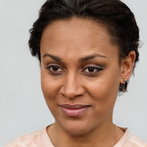 Joyful latino young-adult female with short  brown hair and brown eyes