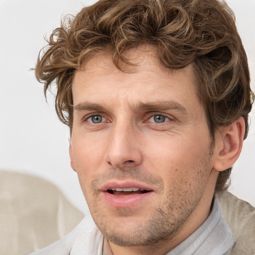 Joyful white adult male with short  brown hair and grey eyes