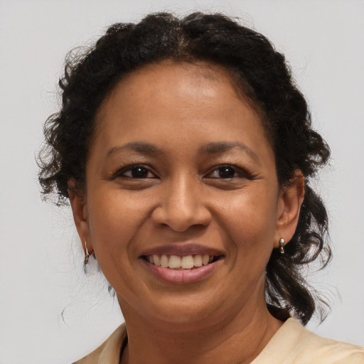 Joyful black adult female with medium  brown hair and brown eyes