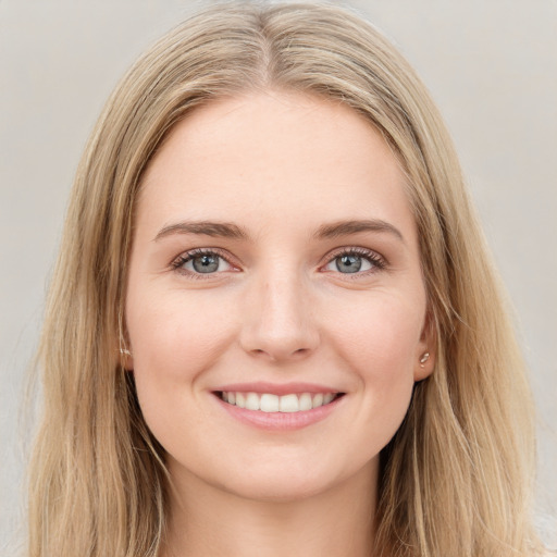 Joyful white young-adult female with long  brown hair and green eyes