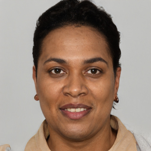 Joyful black young-adult female with short  black hair and brown eyes