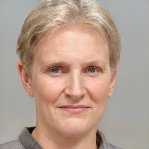 Joyful white adult female with short  brown hair and grey eyes