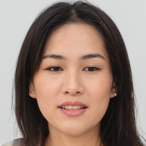 Joyful asian young-adult female with long  brown hair and brown eyes
