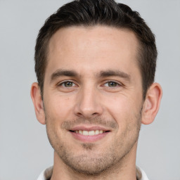 Joyful white young-adult male with short  brown hair and brown eyes