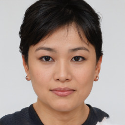 Joyful asian young-adult female with short  brown hair and brown eyes