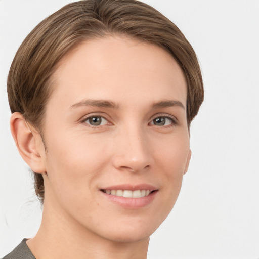 Joyful white young-adult female with short  brown hair and grey eyes