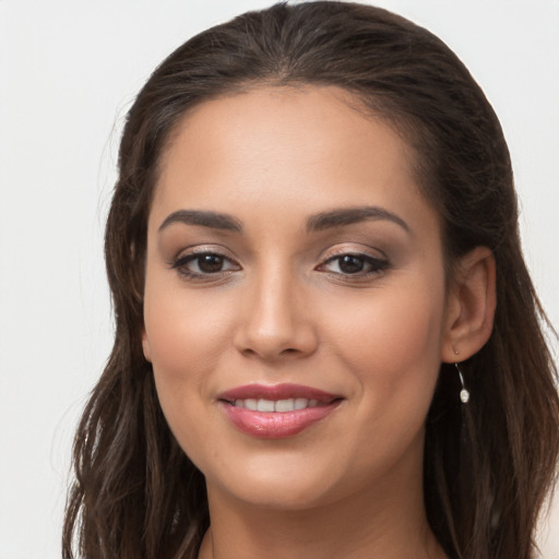 Joyful white young-adult female with long  brown hair and brown eyes