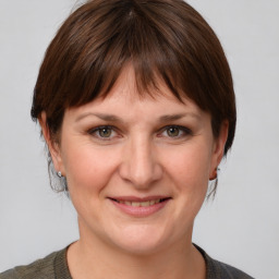 Joyful white adult female with medium  brown hair and grey eyes