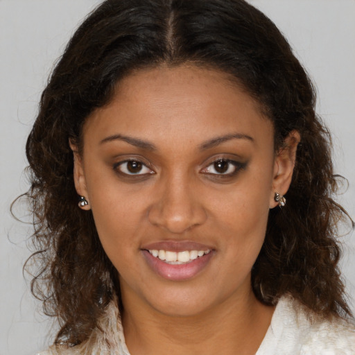 Joyful black young-adult female with medium  brown hair and brown eyes