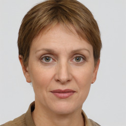 Joyful white adult female with short  brown hair and grey eyes