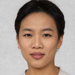 Joyful asian young-adult female with short  brown hair and brown eyes