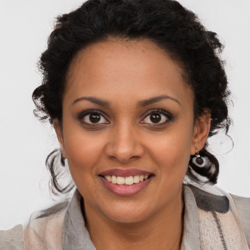 Joyful black young-adult female with long  brown hair and brown eyes