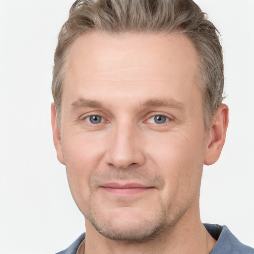 Joyful white adult male with short  brown hair and grey eyes