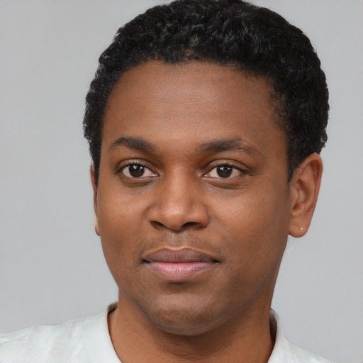 Joyful black young-adult male with short  black hair and brown eyes