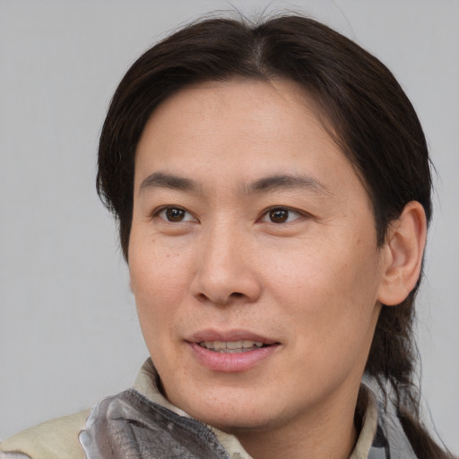 Joyful asian adult female with short  brown hair and brown eyes