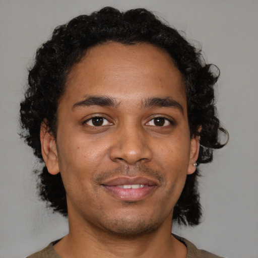 Joyful black young-adult male with short  brown hair and brown eyes