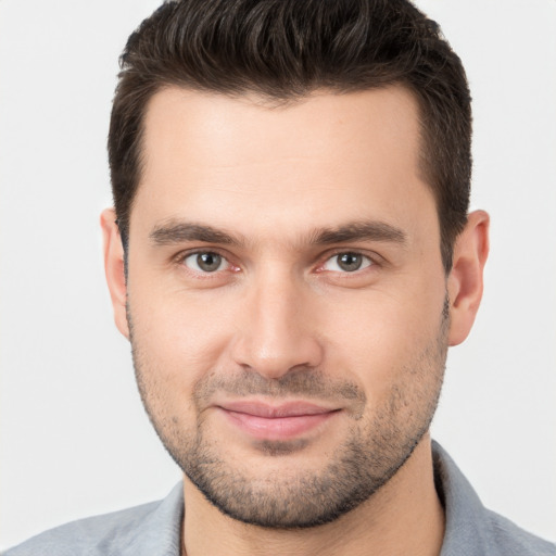 Joyful white young-adult male with short  brown hair and brown eyes